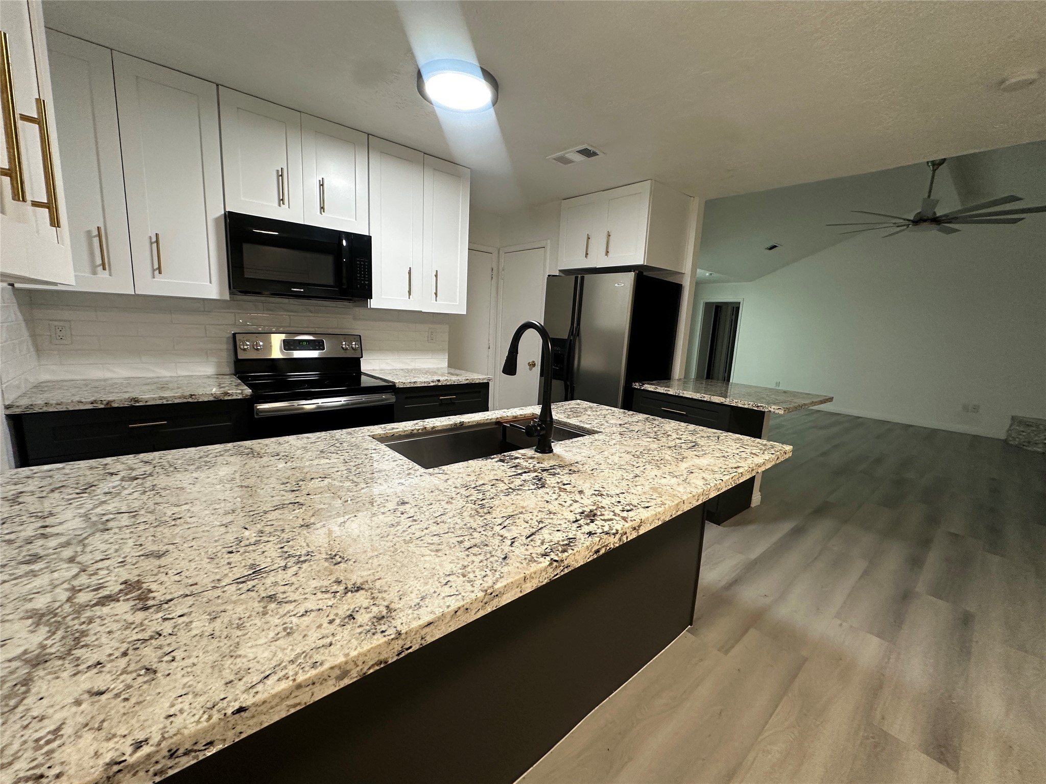 5726 Yorkgate Drive Spring, TX 77373 - Photo 9 of 22 a kitchen with granite countertop stainless steel appliances a sink stove top oven and granite counter top
