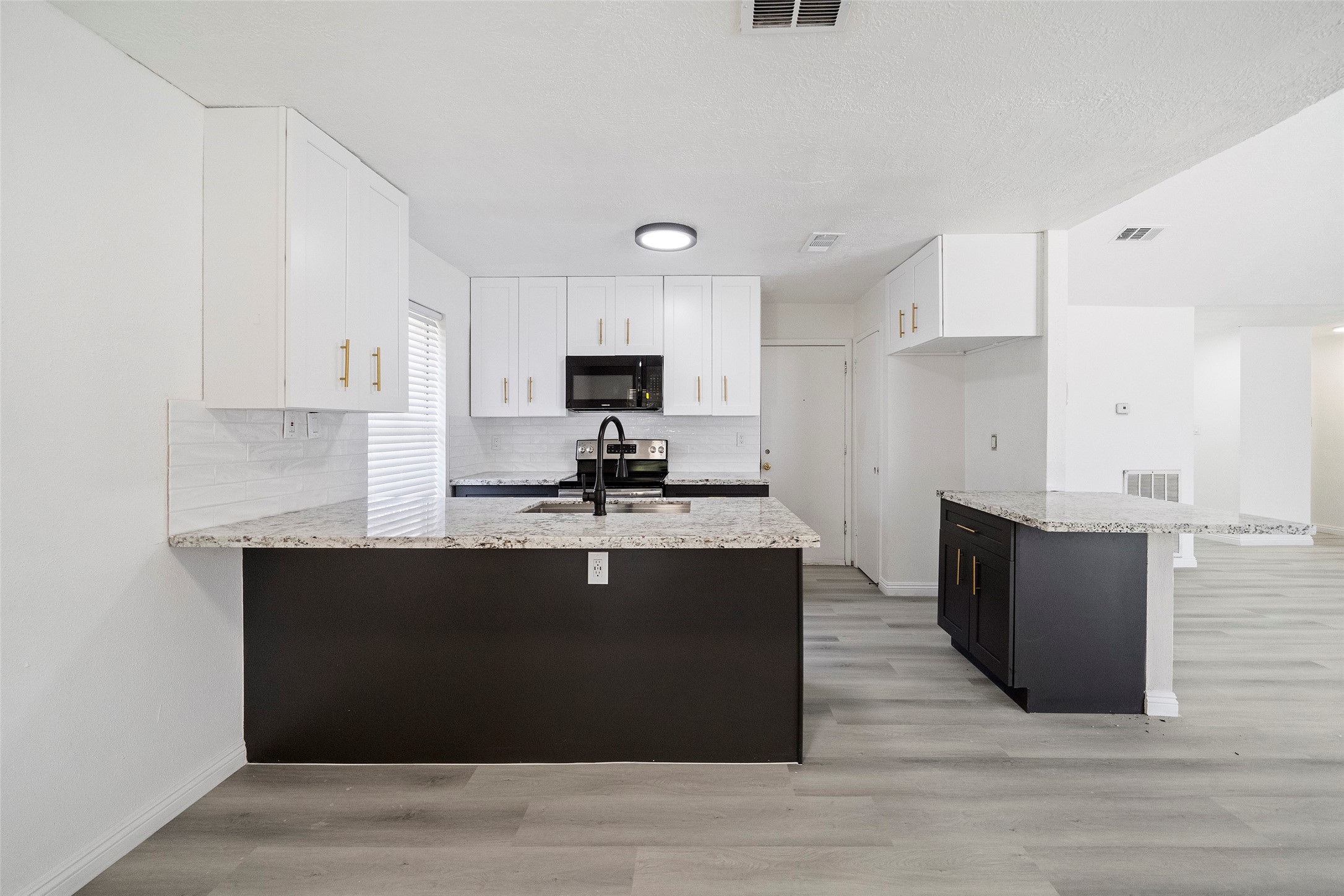5726 Yorkgate Drive Spring, TX 77373 - Photo 10 of 22 a kitchen with stainless steel appliances granite countertop a sink a stove and cabinets