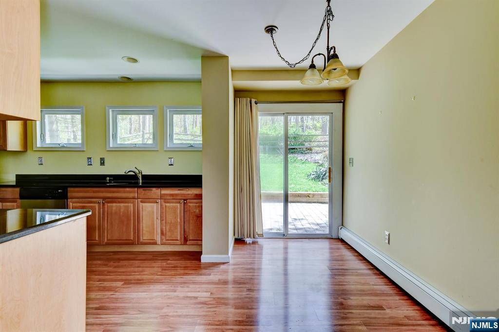 64 Hilltop Trail Sparta, NJ 07871 - Photo 12 of 40 a kitchen with granite countertop wooden floors and wide window