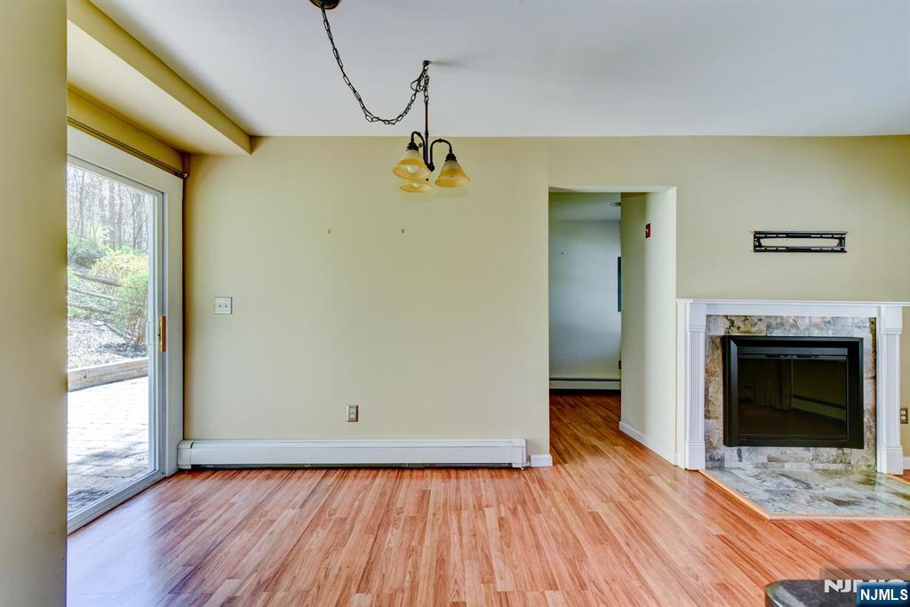 64 Hilltop Trail Sparta, NJ 07871 - Photo 13 of 40 a view of empty room with wooden floor and fireplace