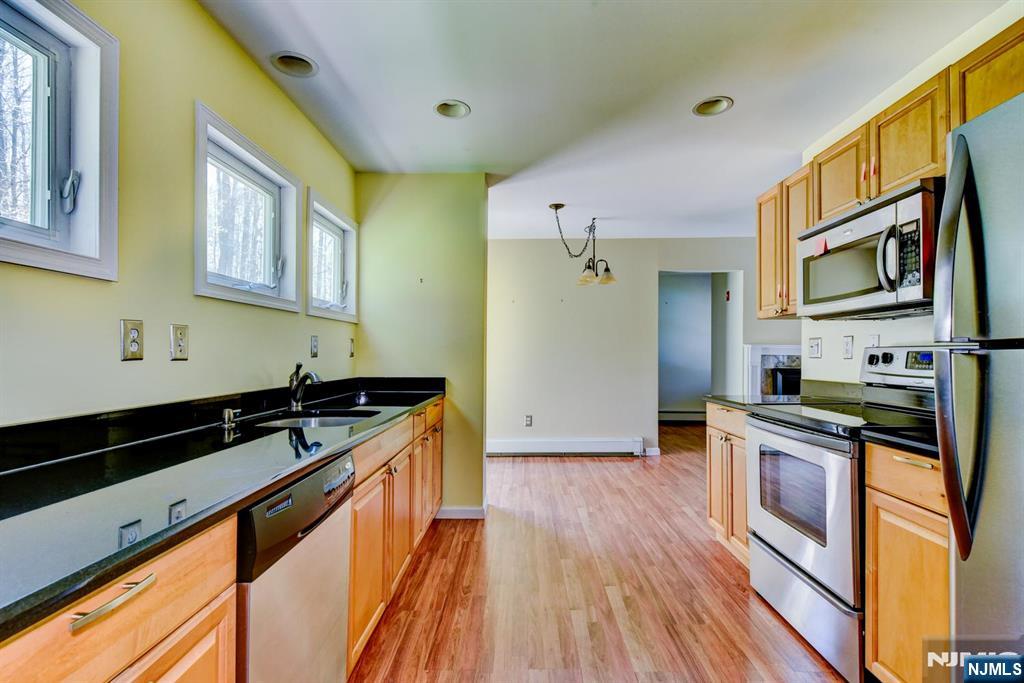 64 Hilltop Trail Sparta, NJ 07871 - Photo 21 of 40 a kitchen with stainless steel appliances granite countertop a stove and a sink