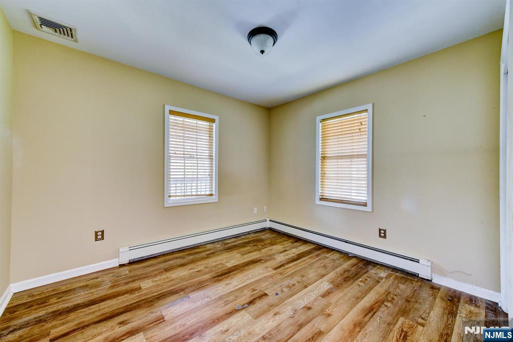 64 Hilltop Trail Sparta, NJ 07871 - Photo 23 of 40 a view of an empty room with wooden floor and a window