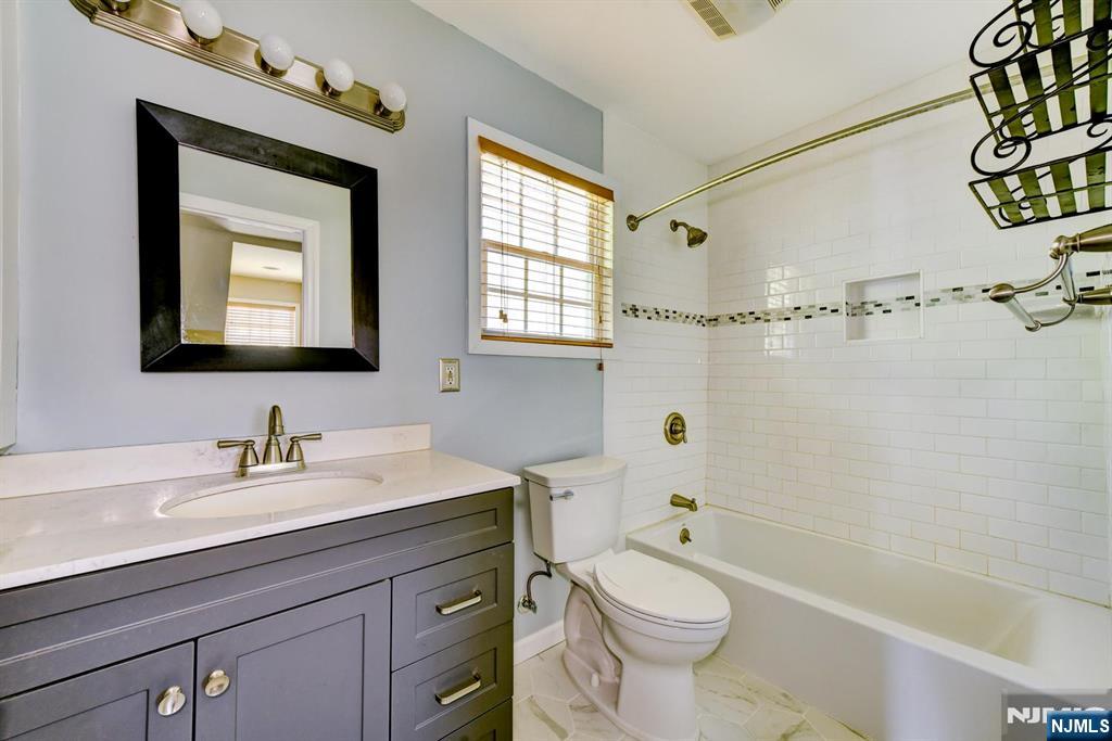 64 Hilltop Trail Sparta, NJ 07871 - Photo 34 of 40 a bathroom with a granite countertop toilet sink and a bathtub