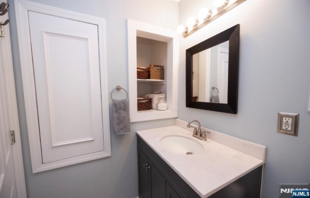 64 Hilltop Trail Sparta, NJ 07871 - Photo 35 of 40 a bathroom with a sink vanity and a mirror