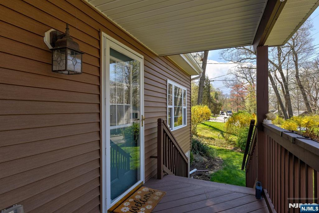 64 Hilltop Trail Sparta, NJ 07871 - Photo 6 of 40 a view of a porch with wooden floor chairs and stairs