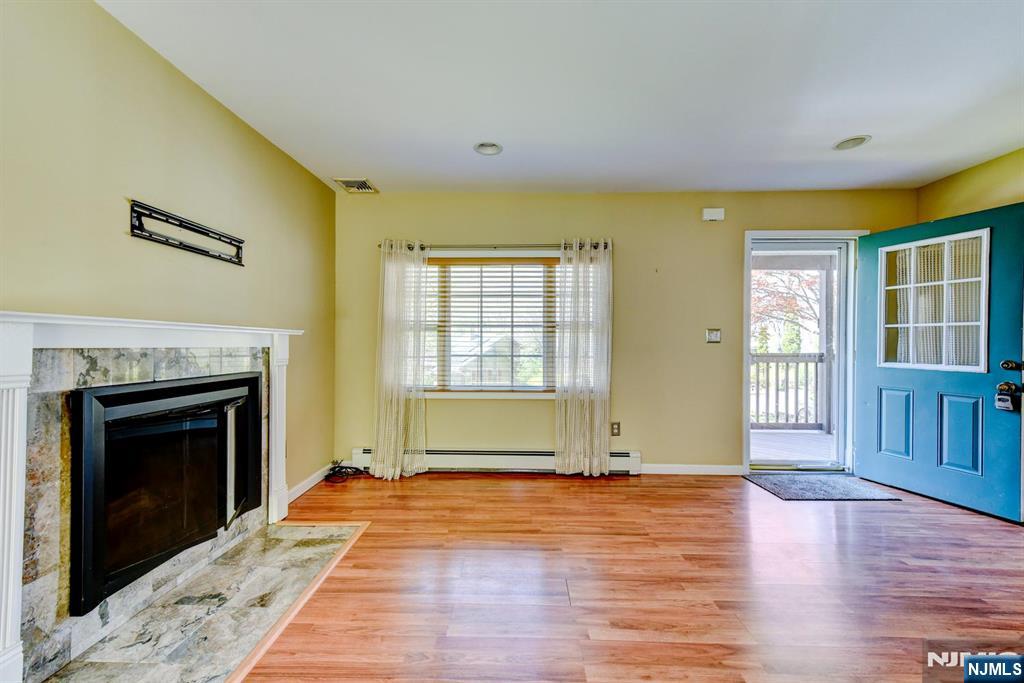 64 Hilltop Trail Sparta, NJ 07871 - Photo 9 of 40 a view of an empty room with glass door and wooden floor