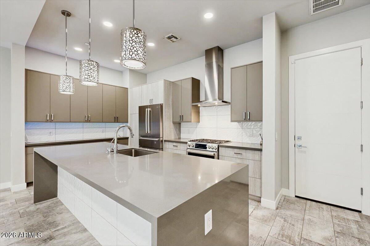 2645 East Osborn Road, Unit 3 Phoenix, AZ 85016 - Photo 4 of 14 a kitchen with kitchen island a counter top space appliances and cabinets
