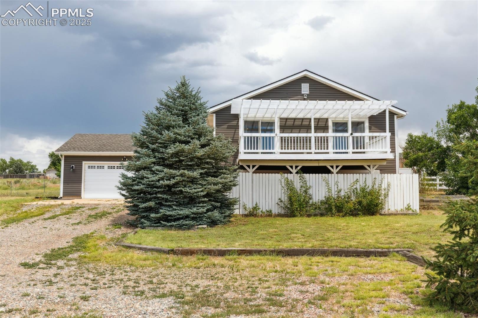 10925 Double D Road Fountain, CO 80817 - Photo 1 of 33 View of front facade featuring a pergola, driveway, and a garage