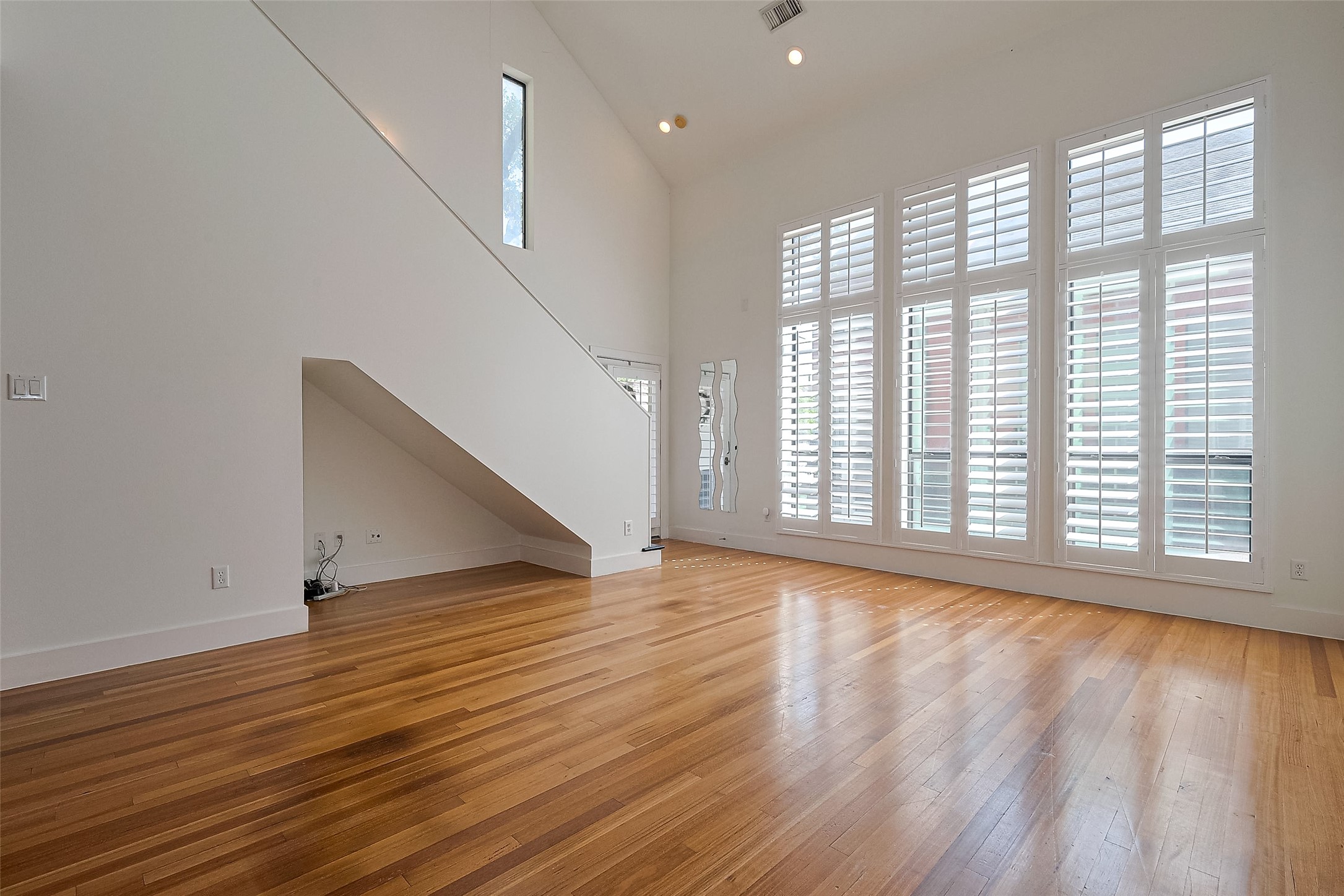 4331 Eigel Street Houston, TX 77007 - Photo 7 of 38 a view of an empty room with wooden floor and a window