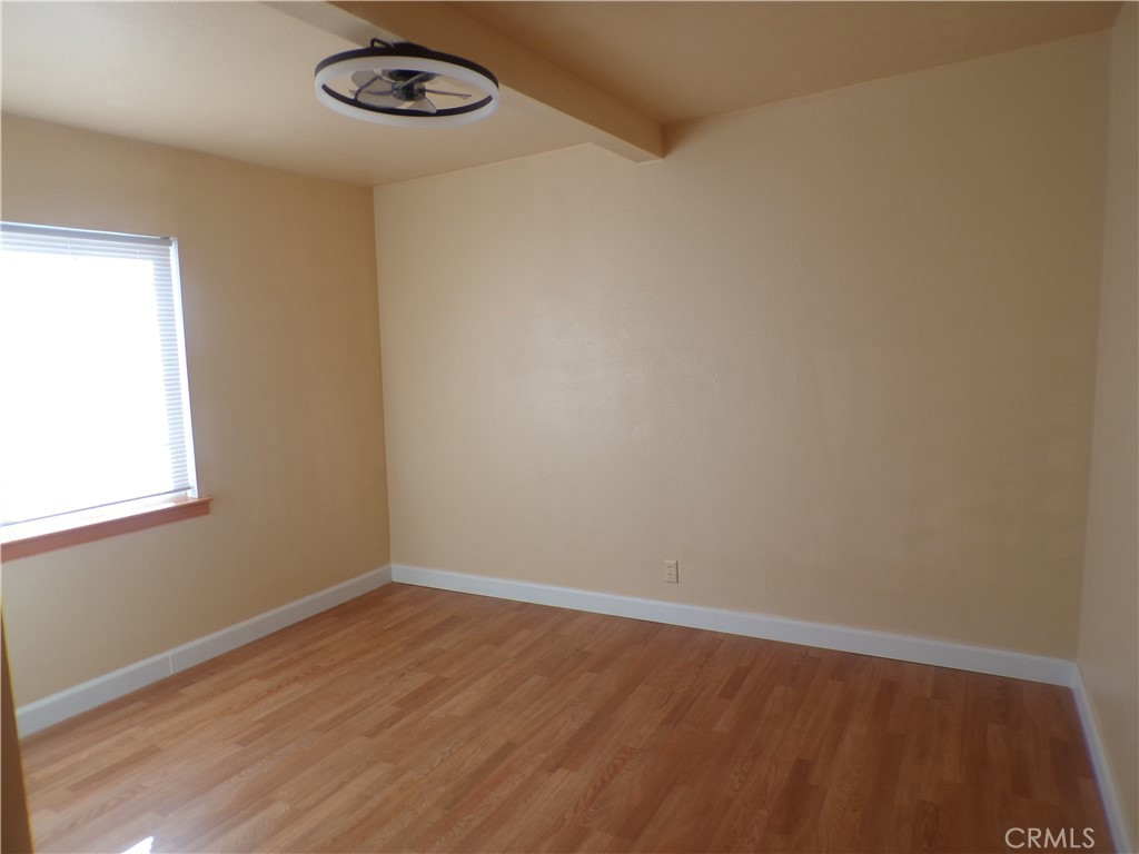 16183 18th Avenue Clearlake, CA 95422 - Photo 11 of 21 an empty room with wooden floor and windows