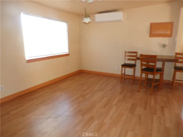a workspace room with wooden floor table and chair
