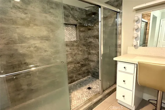 a bathroom with a shower and a sink