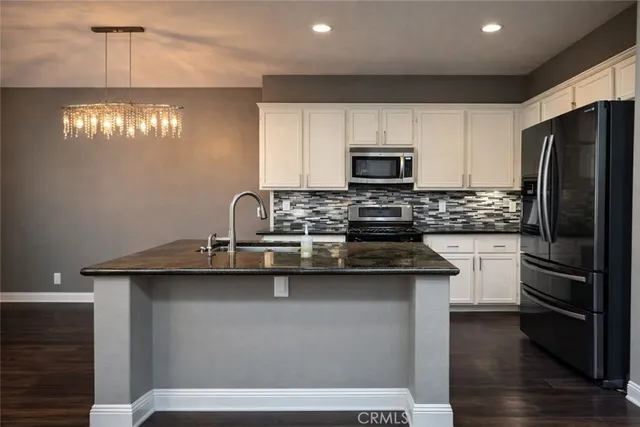 a kitchen with stainless steel appliances a sink stove and refrigerator