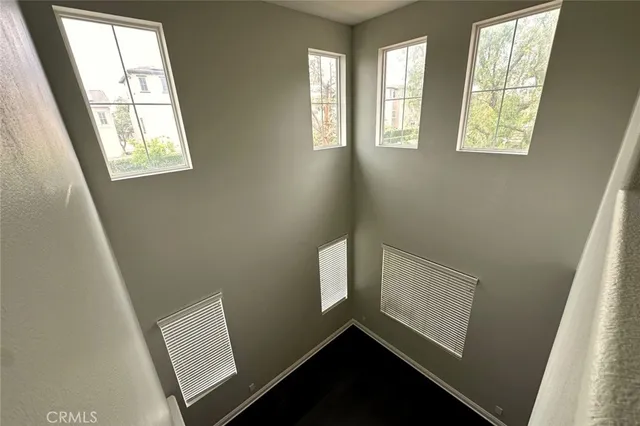 a view of an empty room with windows