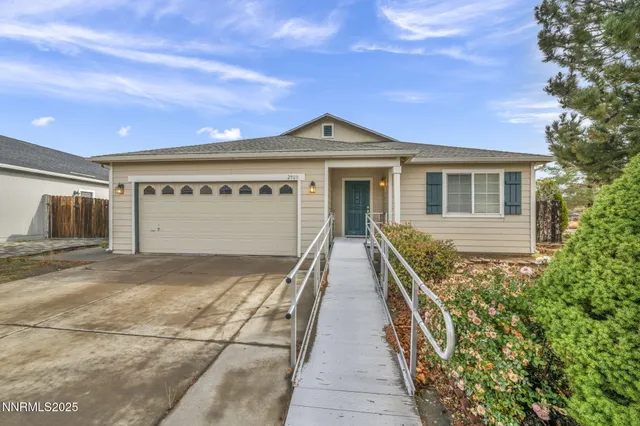 a view of a house with wooden fence