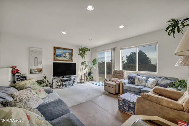 a bedroom with a bed and a flat tv screen on the dresser
