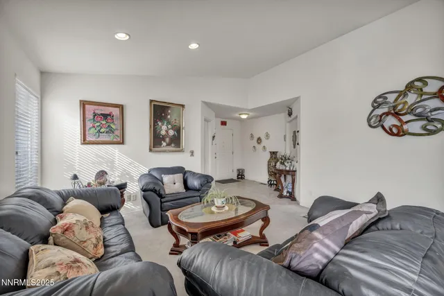 a living room with furniture and painting on the wall
