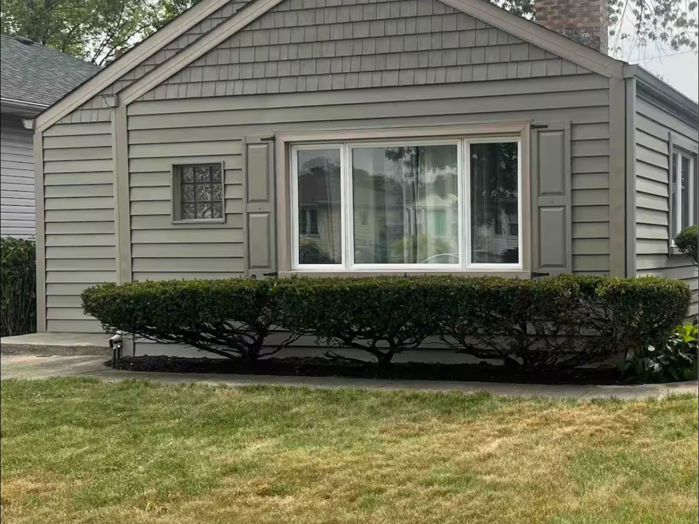 a front view of a house with a small yard