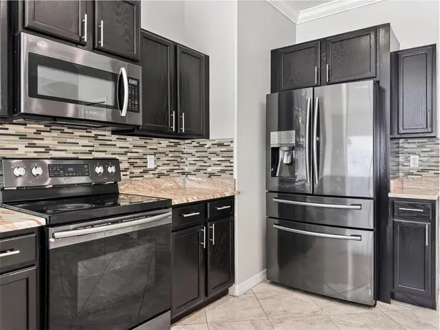 a kitchen with refrigerator and microwave