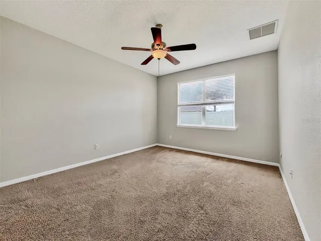 a white toilet sitting next to a white wall