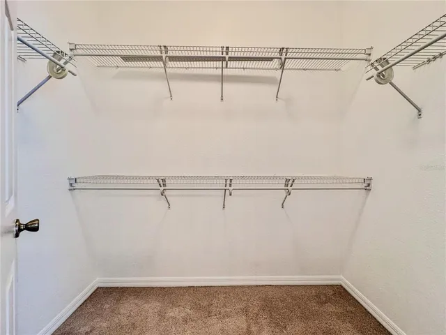 a bedroom with a large bed and a flat screen tv