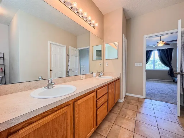 an empty room with chandelier fan