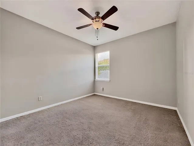 a bathroom with a granite countertop sink a toilet a mirror and shower