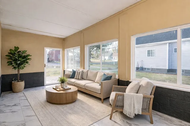 a living room with furniture and a potted plant