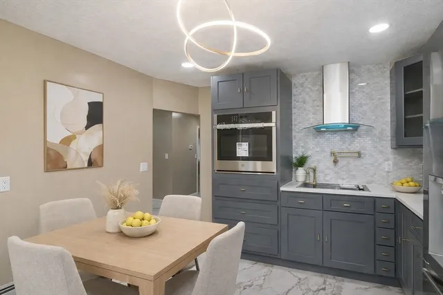 a kitchen with a sink cabinets and wooden floor