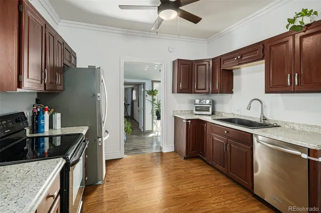 a kitchen with stainless steel appliances granite countertop a sink stove and refrigerator