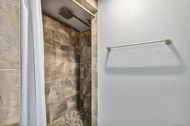 a bathroom with a glass shower door