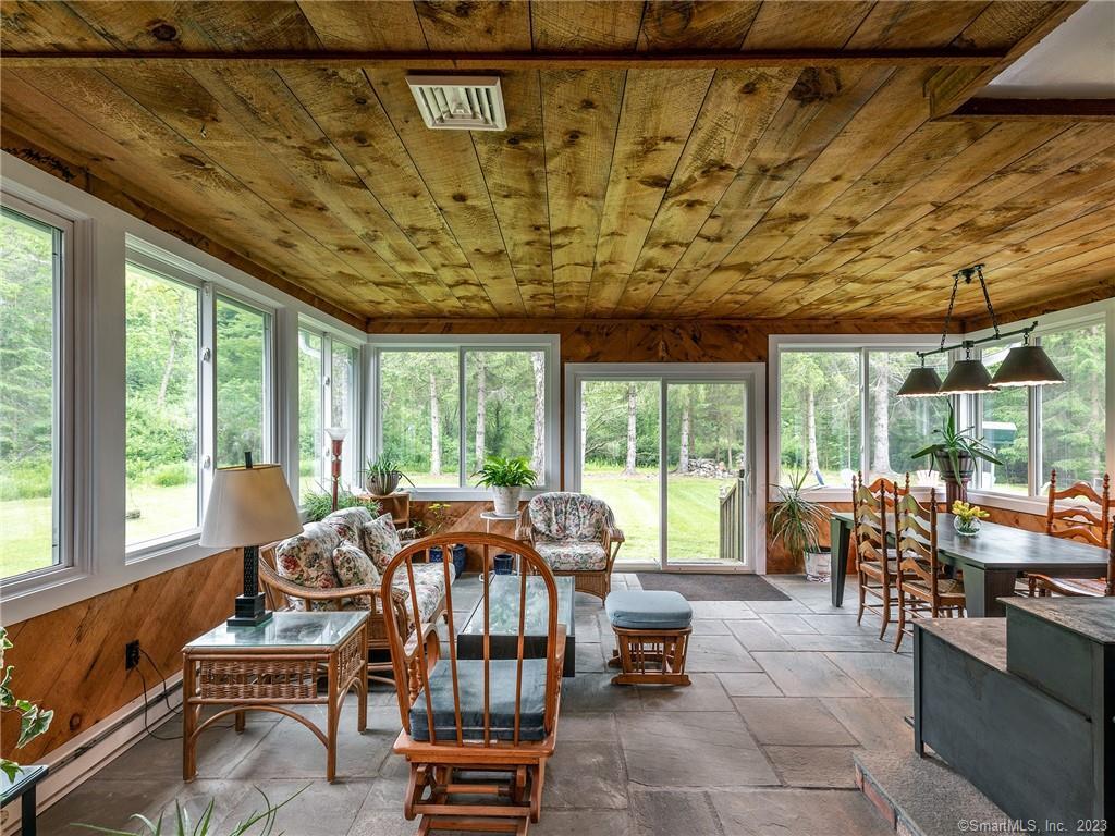 23 Cornwall Road Warren, CT 06754 - Photo 10 of 39 sunroom with gorgeous windows looking out onto backyard and firepit area