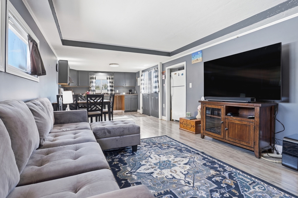 181 Boston Post Road East, Unit 34 Marlborough, MA 01752 - Photo 12 of 29 a living room with furniture and a flat screen tv