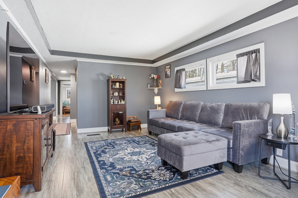 181 Boston Post Road East, Unit 34 Marlborough, MA 01752 - Photo 24 of 29 a living room with furniture and a flat screen tv