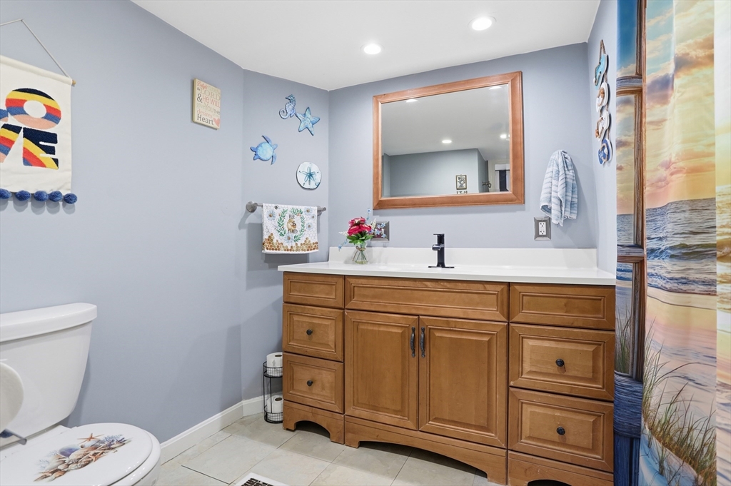 181 Boston Post Road East, Unit 34 Marlborough, MA 01752 - Photo 25 of 29 a bathroom with a toilet sink and mirror