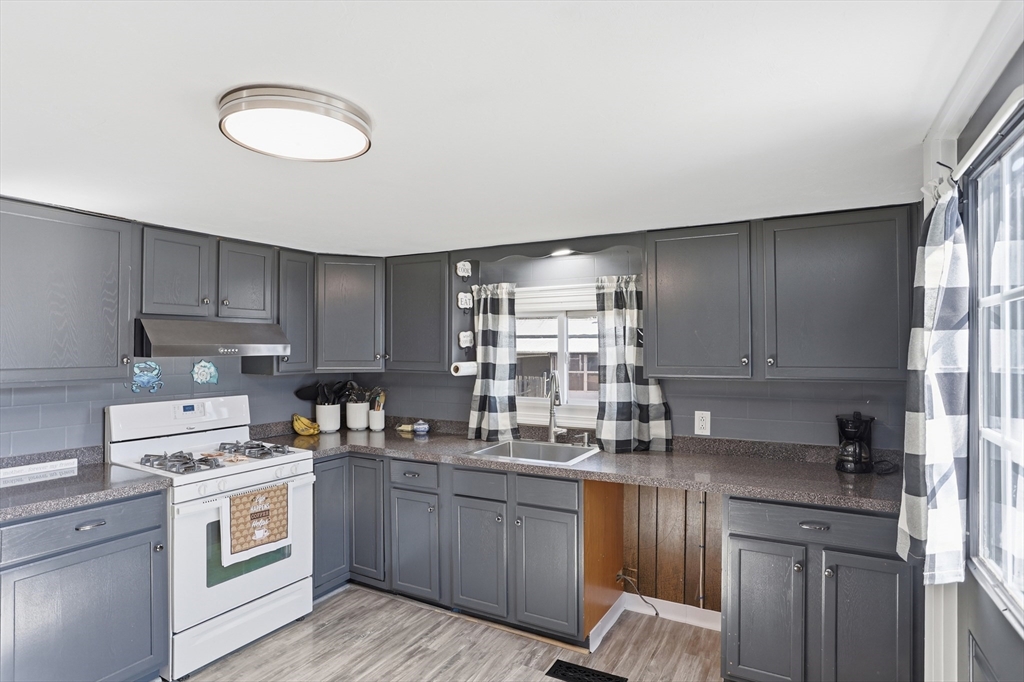 181 Boston Post Road East, Unit 34 Marlborough, MA 01752 - Photo 7 of 29 a kitchen with kitchen island granite countertop a sink cabinets stainless steel appliances and a counter space