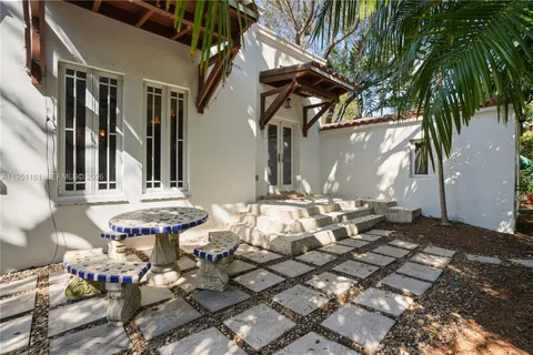 a couple of table and chairs in a patio