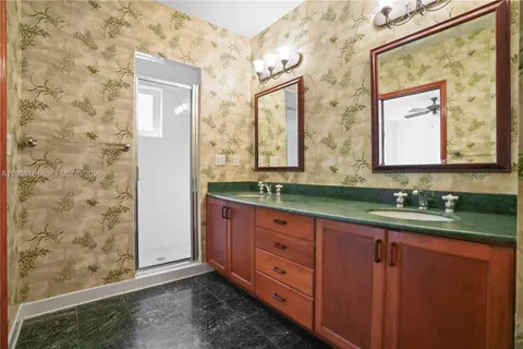 a bathroom with a granite countertop sink mirror and double
