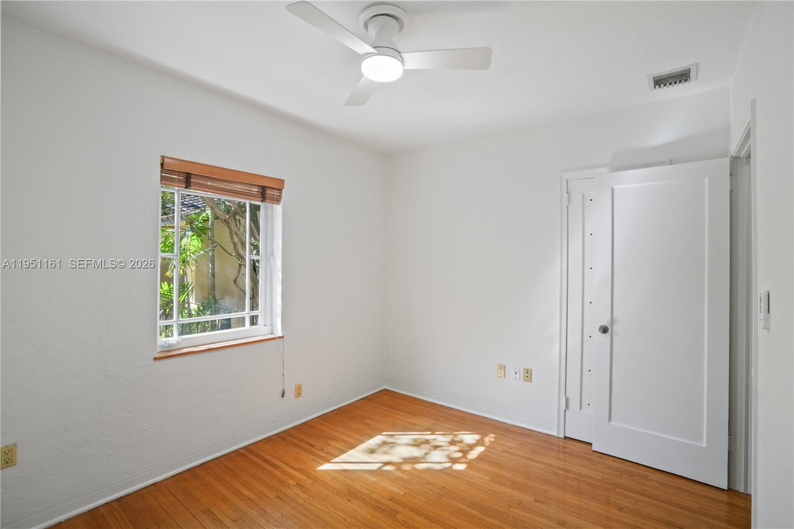 1413 El Rado Street Coral Gables, FL 33134 - Photo 19 of 20 a view of an empty room with window and wooden floor
