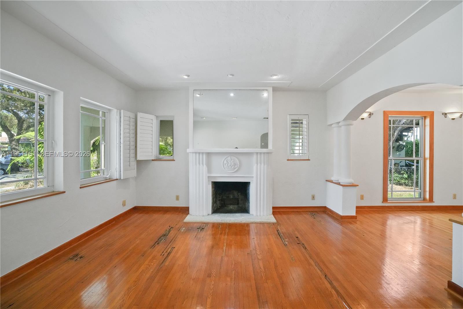 1413 El Rado Street Coral Gables, FL 33134 - Photo 2 of 20 wooden floor fireplace and windows in an empty room