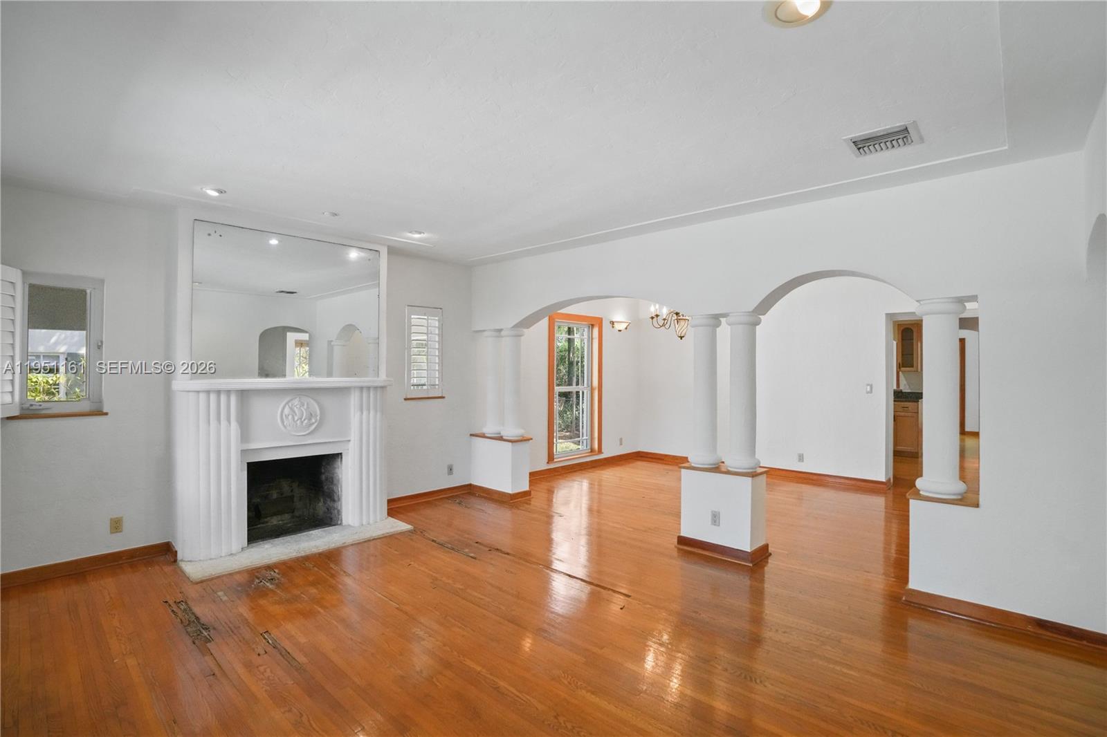 1413 El Rado Street Coral Gables, FL 33134 - Photo 3 of 20 a view of an empty room with wooden floor fireplace and a window