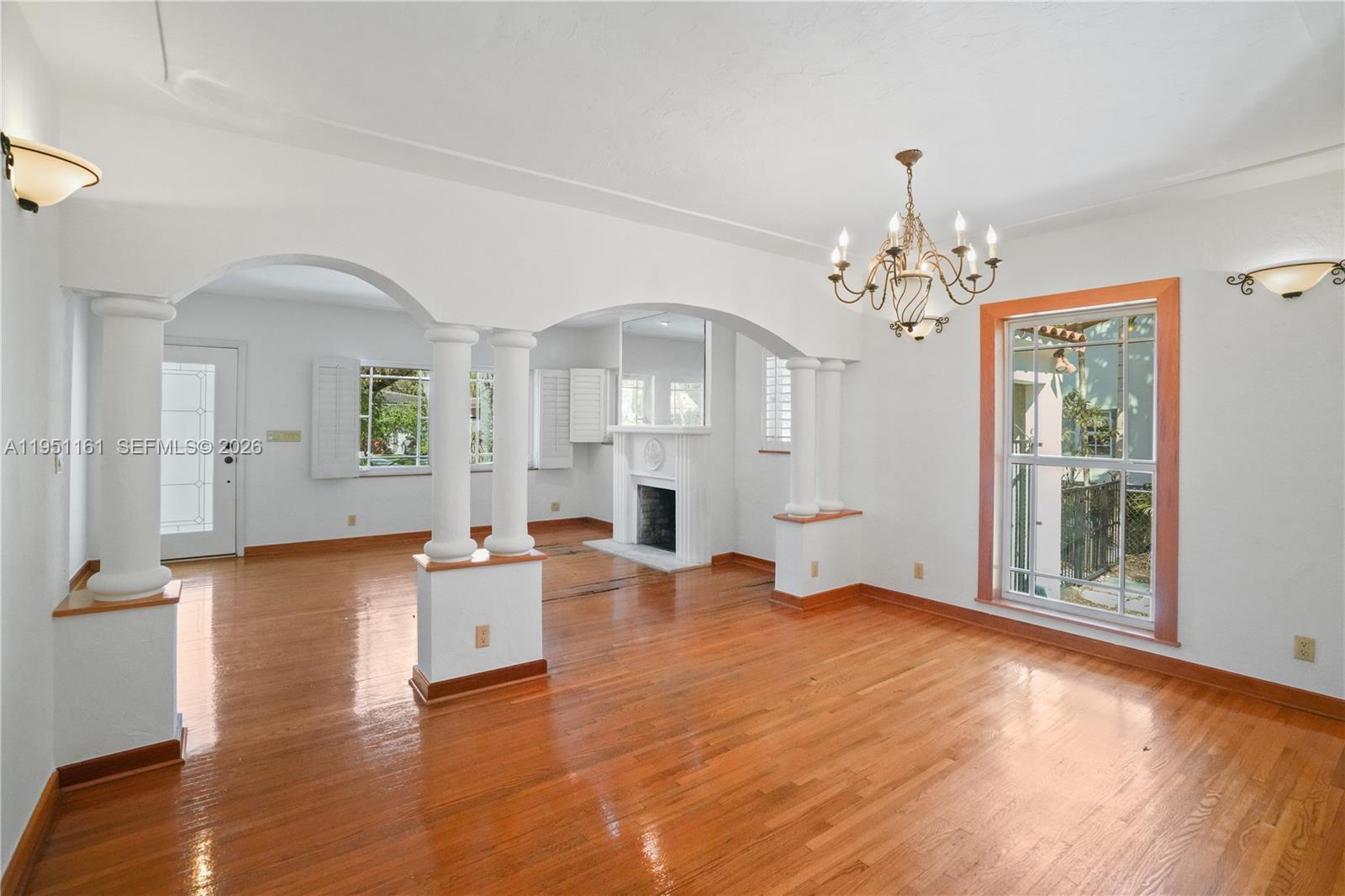 1413 El Rado Street Coral Gables, FL 33134 - Photo 4 of 20 a view of a livingroom with furniture wooden floor a chandelier and windows