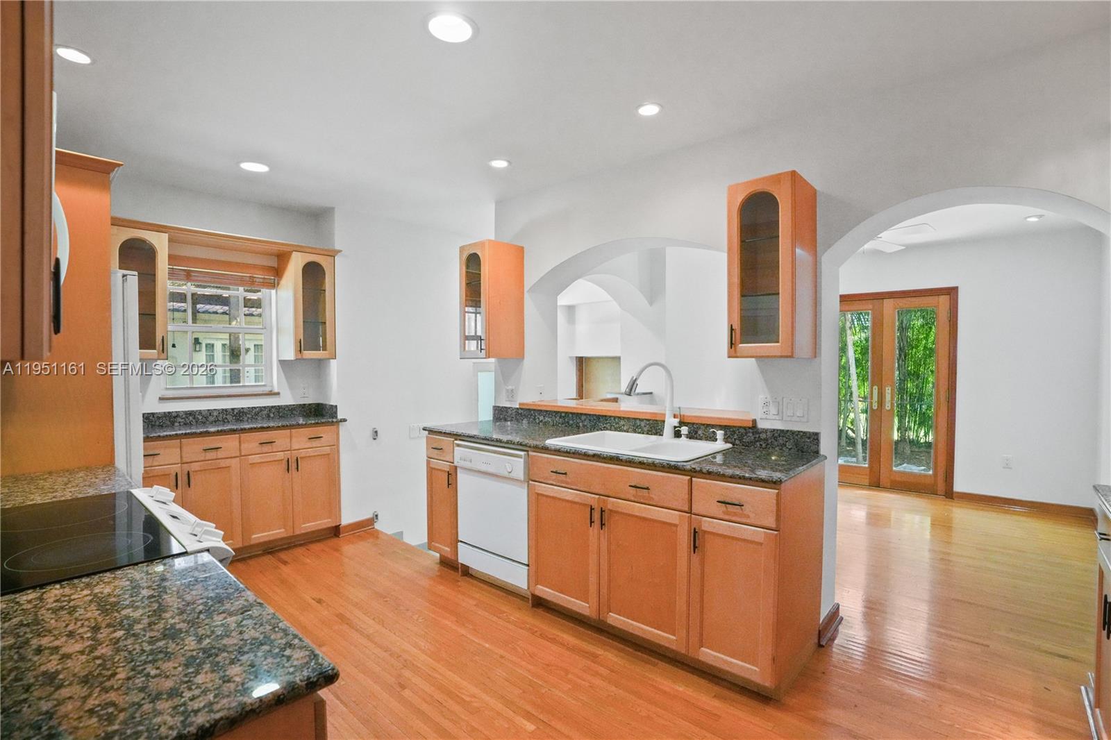 1413 El Rado Street Coral Gables, FL 33134 - Photo 6 of 20 a kitchen with stainless steel appliances granite countertop a stove a sink and a wooden cabinets