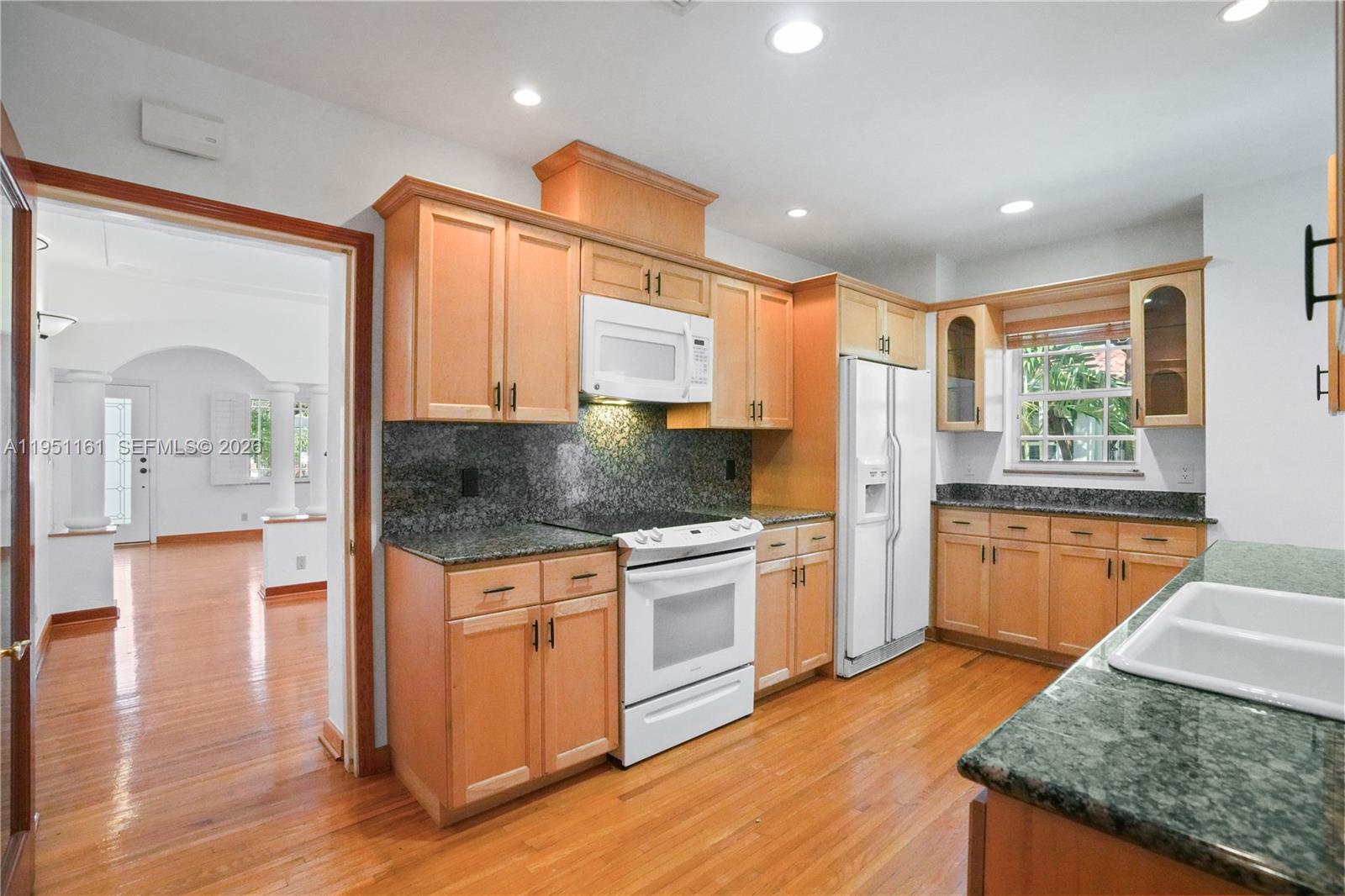 1413 El Rado Street Coral Gables, FL 33134 - Photo 7 of 20 a kitchen with stainless steel appliances granite countertop a stove a sink and a refrigerator