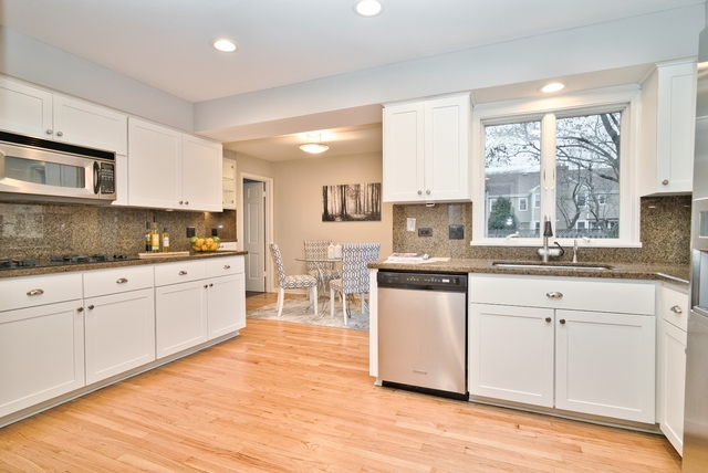 4052 Michelline Lane Northbrook, IL 60062 - Photo 11 of 44 a kitchen with white cabinets sink and appliances