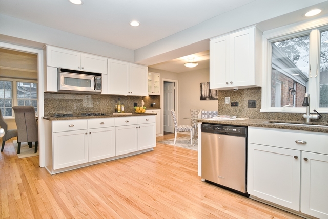 4052 Michelline Lane Northbrook, IL 60062 - Photo 12 of 44 a kitchen with granite countertop a sink cabinets and wooden floor