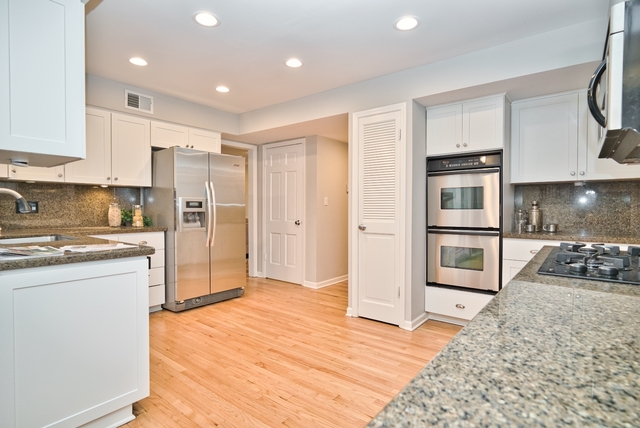 4052 Michelline Lane Northbrook, IL 60062 - Photo 15 of 44 a kitchen with stainless steel appliances kitchen island granite countertop a refrigerator and a sink