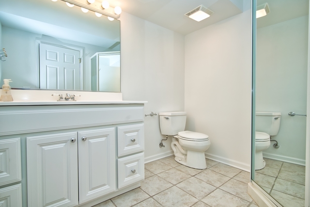 4052 Michelline Lane Northbrook, IL 60062 - Photo 22 of 44 a bathroom with a sink a toilet and a mirror