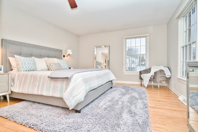 4052 Michelline Lane Northbrook, IL 60062 - Photo 26 of 44 a bedroom with a bed and wooden floor