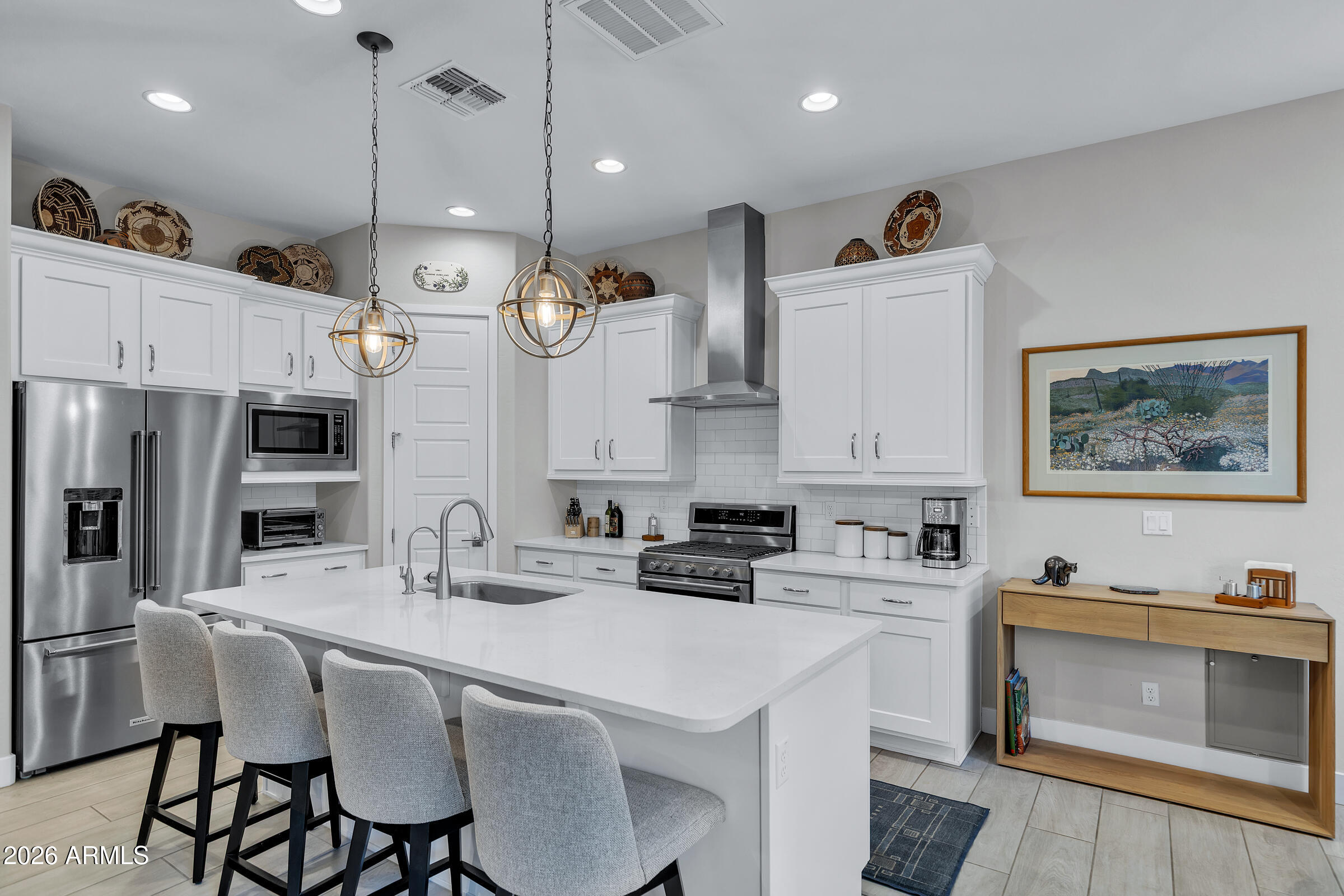 622 West Deer Creek Road Phoenix, AZ 85048 - Photo 6 of 39 a kitchen with stainless steel appliances kitchen island granite countertop a sink a stove a refrigerator and cabinets with wooden floor